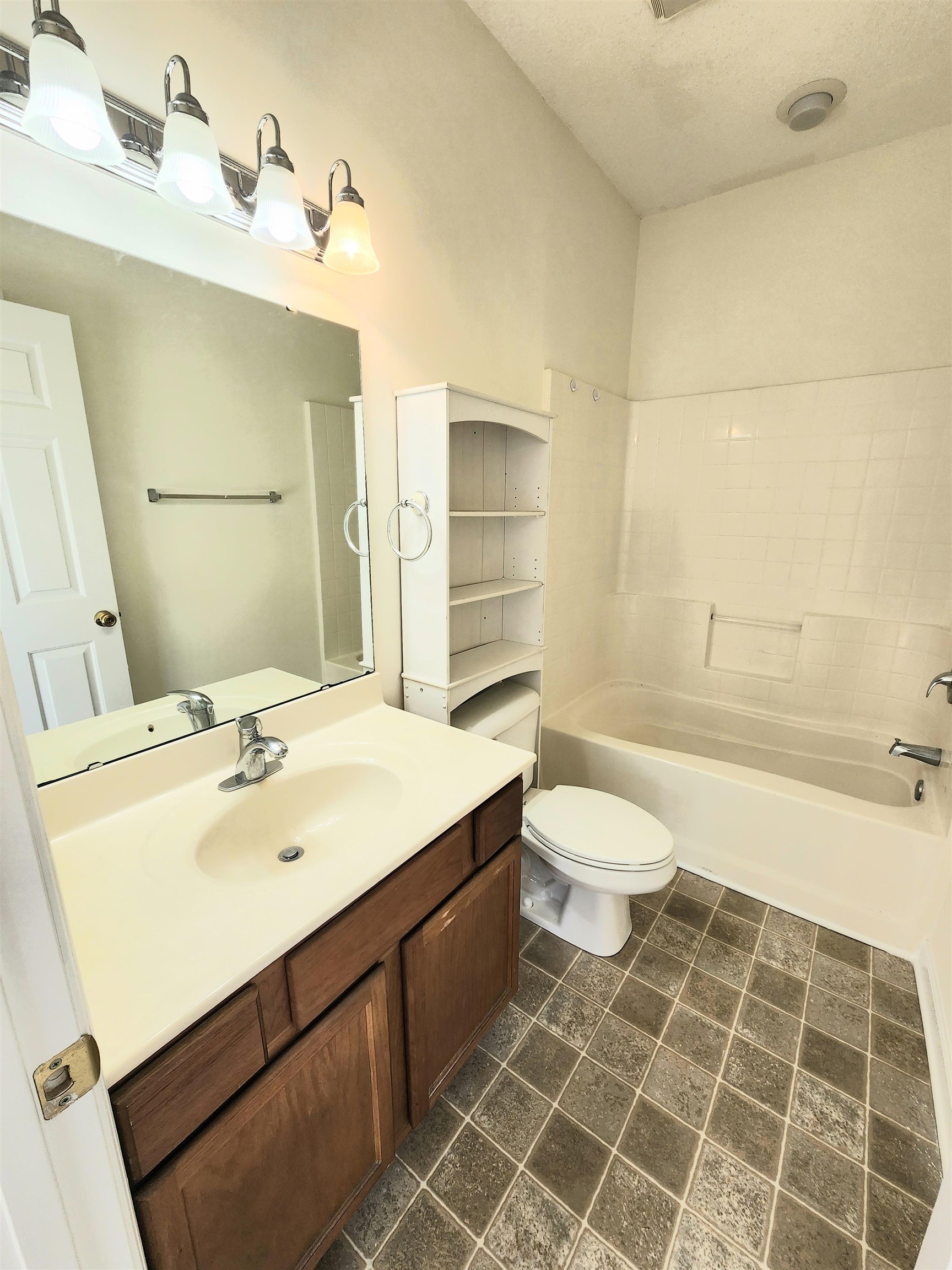 2080 Cross Gate Boulevard, Unit 105 Myrtle Beach, SC 29575 - Photo 20 of 25 Bathroom with vanity, dark tile patterned floors, and bathing tub / shower combination