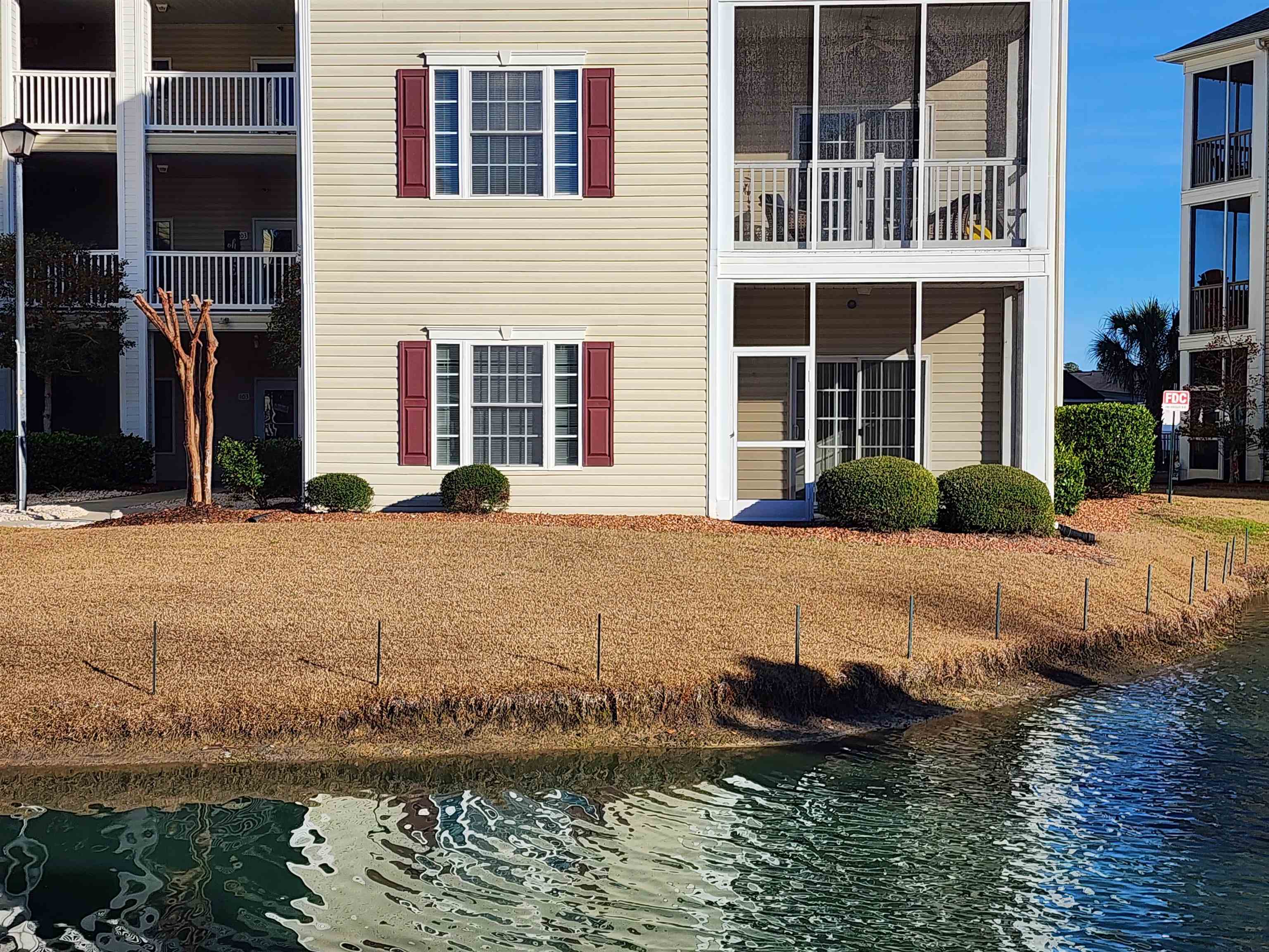 2080 Cross Gate Boulevard, Unit 105 Myrtle Beach, SC 29575 - Photo 22 of 25 Back of property with a water view and a balcony