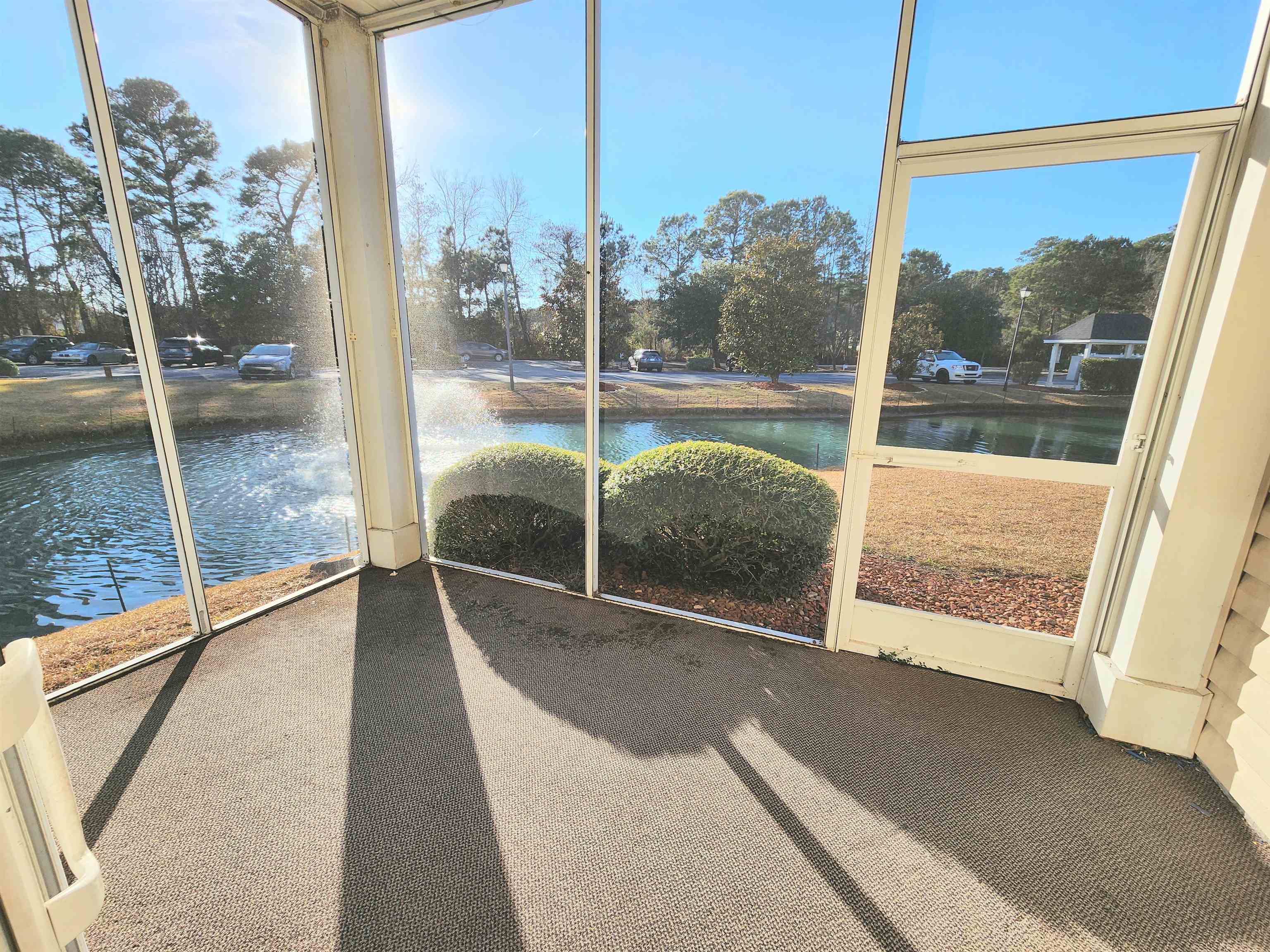 2080 Cross Gate Boulevard, Unit 105 Myrtle Beach, SC 29575 - Photo 5 of 25 Unfurnished sunroom with healthy amount of natural light and a water view