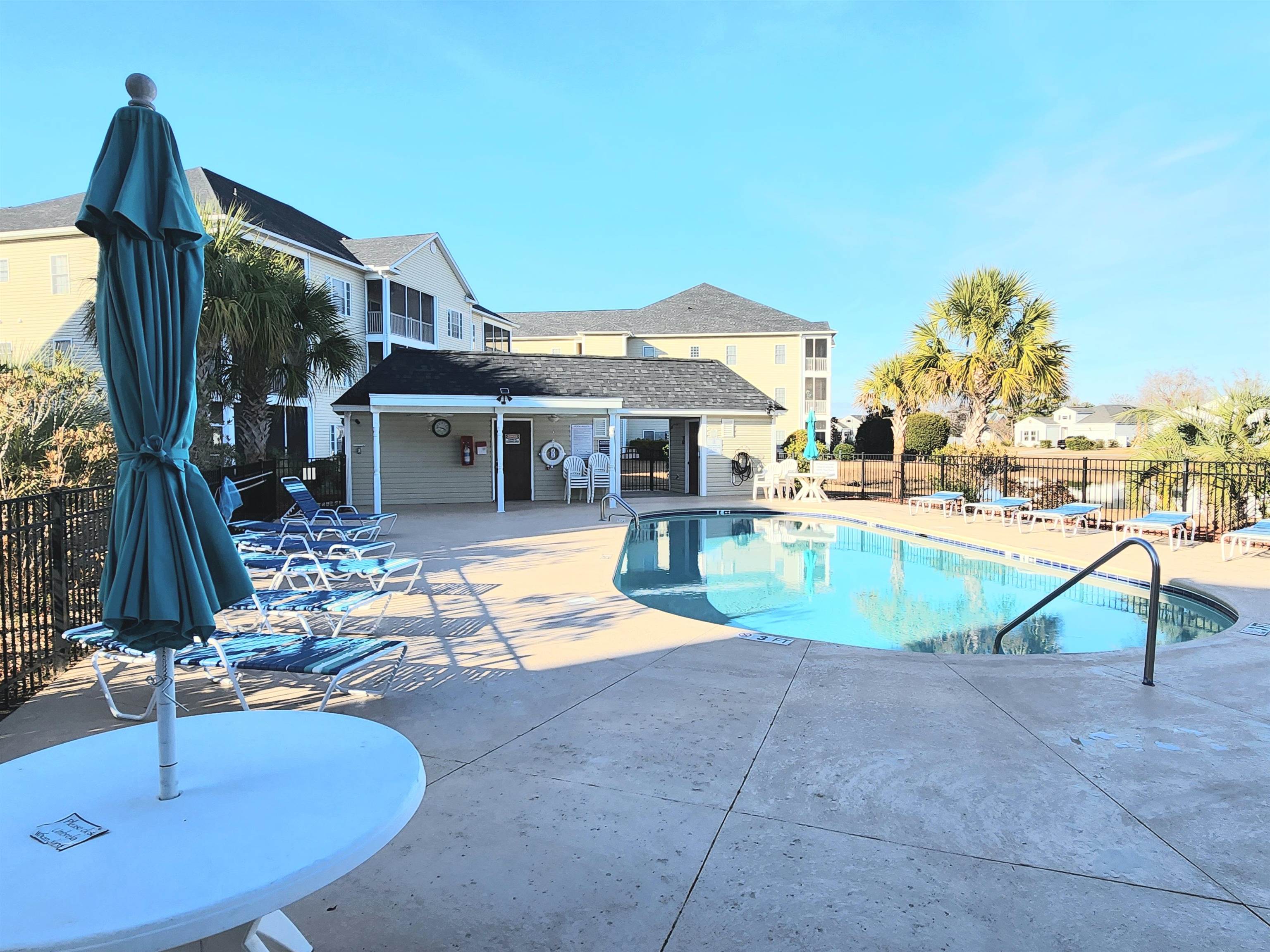2080 Cross Gate Boulevard, Unit 105 Myrtle Beach, SC 29575 - Photo 7 of 25 Community pool with a patio area