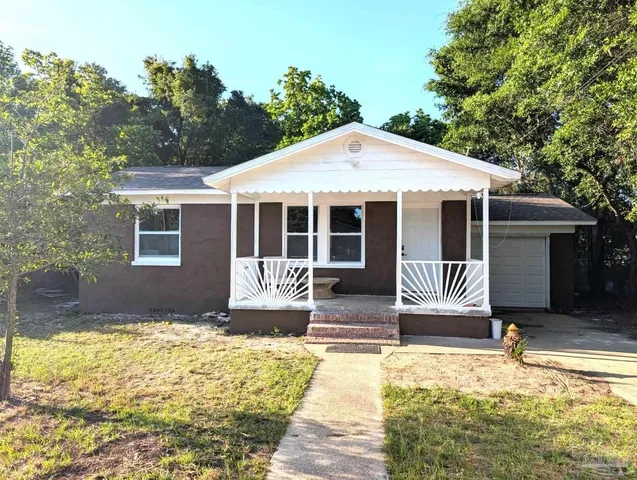 a front view of a house with a garden