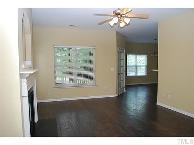3117 Rendezvous Drive Raleigh, NC 27610 - Photo 4 of 22 a view of an empty room with a window and wooden floor