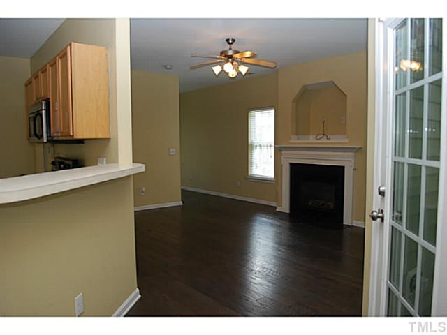 3117 Rendezvous Drive Raleigh, NC 27610 - Photo 6 of 22 a view of a living room with a fireplace and wooden floor