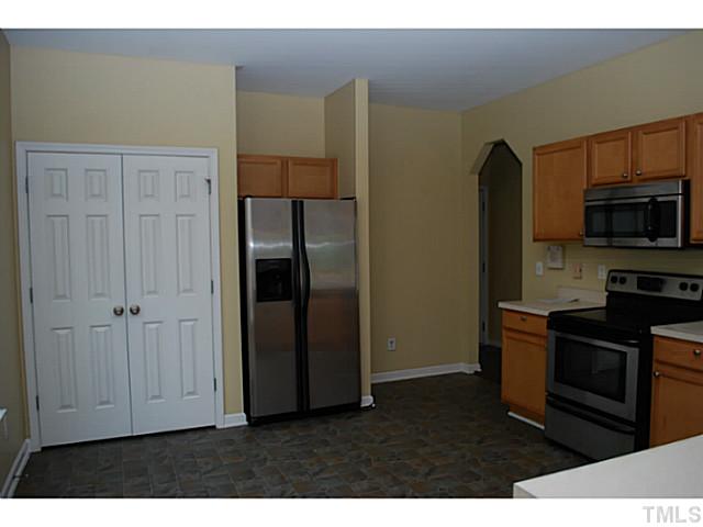 3117 Rendezvous Drive Raleigh, NC 27610 - Photo 8 of 22 a kitchen with stainless steel appliances granite countertop a refrigerator and a stove top oven