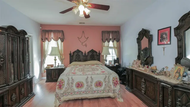 a bedroom with a bed dresser and a window