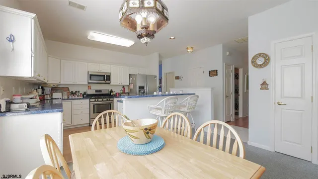 a kitchen with a dining table and chairs
