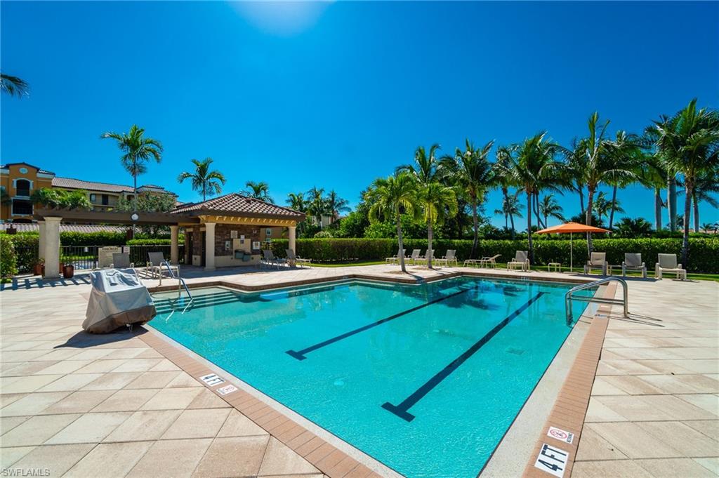 9590 Trevi Court, Unit 5317 Naples, FL 34113 - Photo 23 of 38 a view of a swimming pool with a patio and a yard