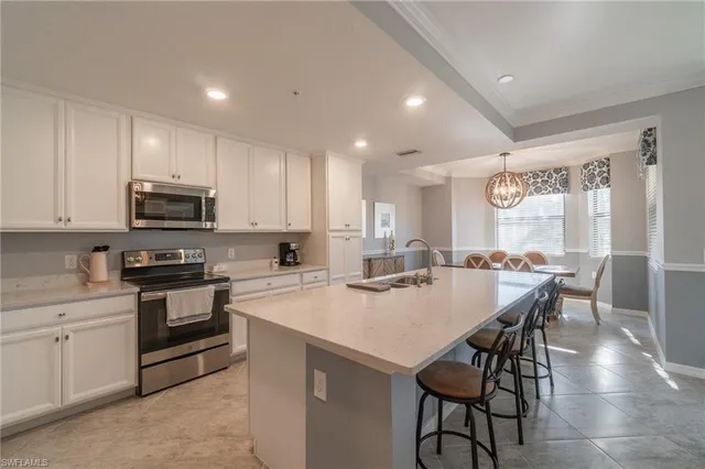 a kitchen with a stove a sink and a microwave