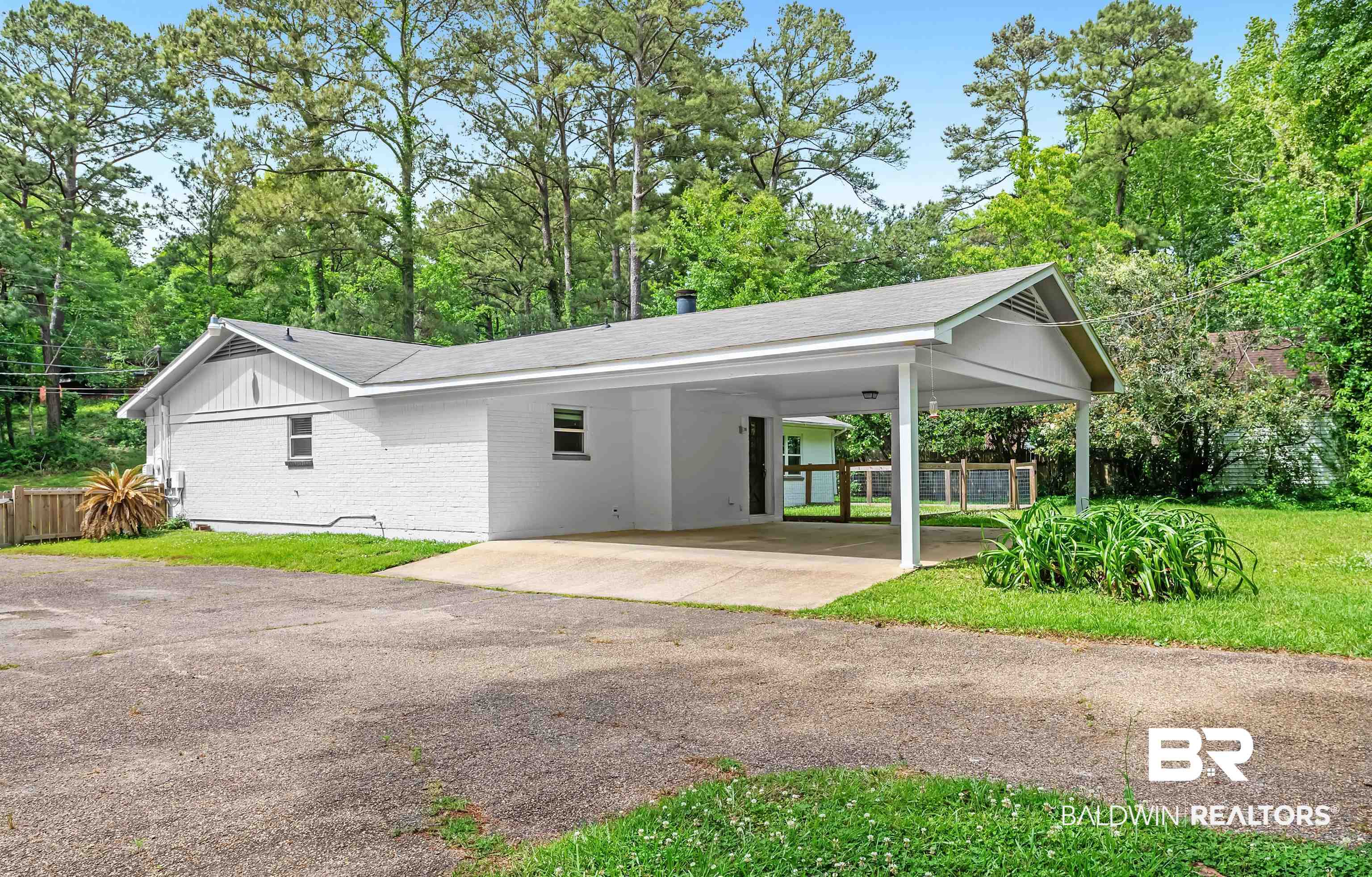 28 Caisson Trace Spanish Fort, AL 36527 - Photo 41 of 51 driveway, a carport, brick siding, and fence