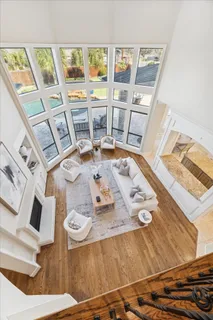 a spacious bathroom with a tub double sink and a mirror