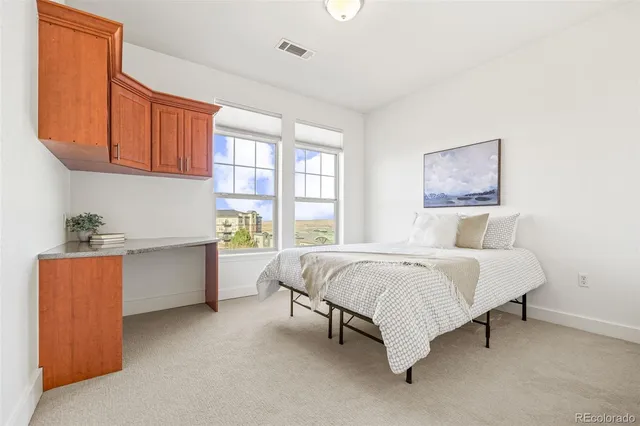 a spacious bedroom with a large bed and a window