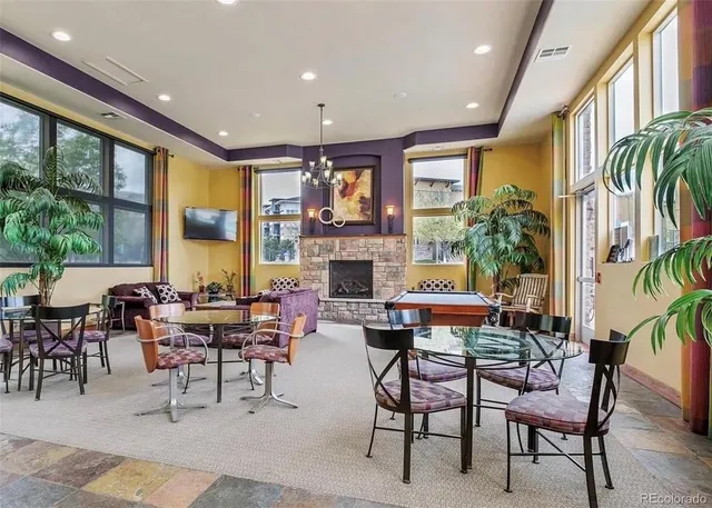 a living room with fireplace furniture and a large window