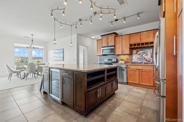 a kitchen with a stove a refrigerator and windows