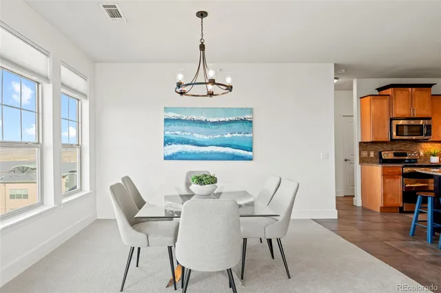 a view of a dining room with furniture large window and wooden floor