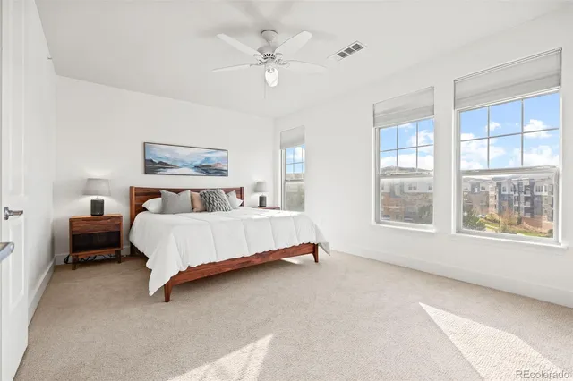 a bed sitting in a bedroom next to a window