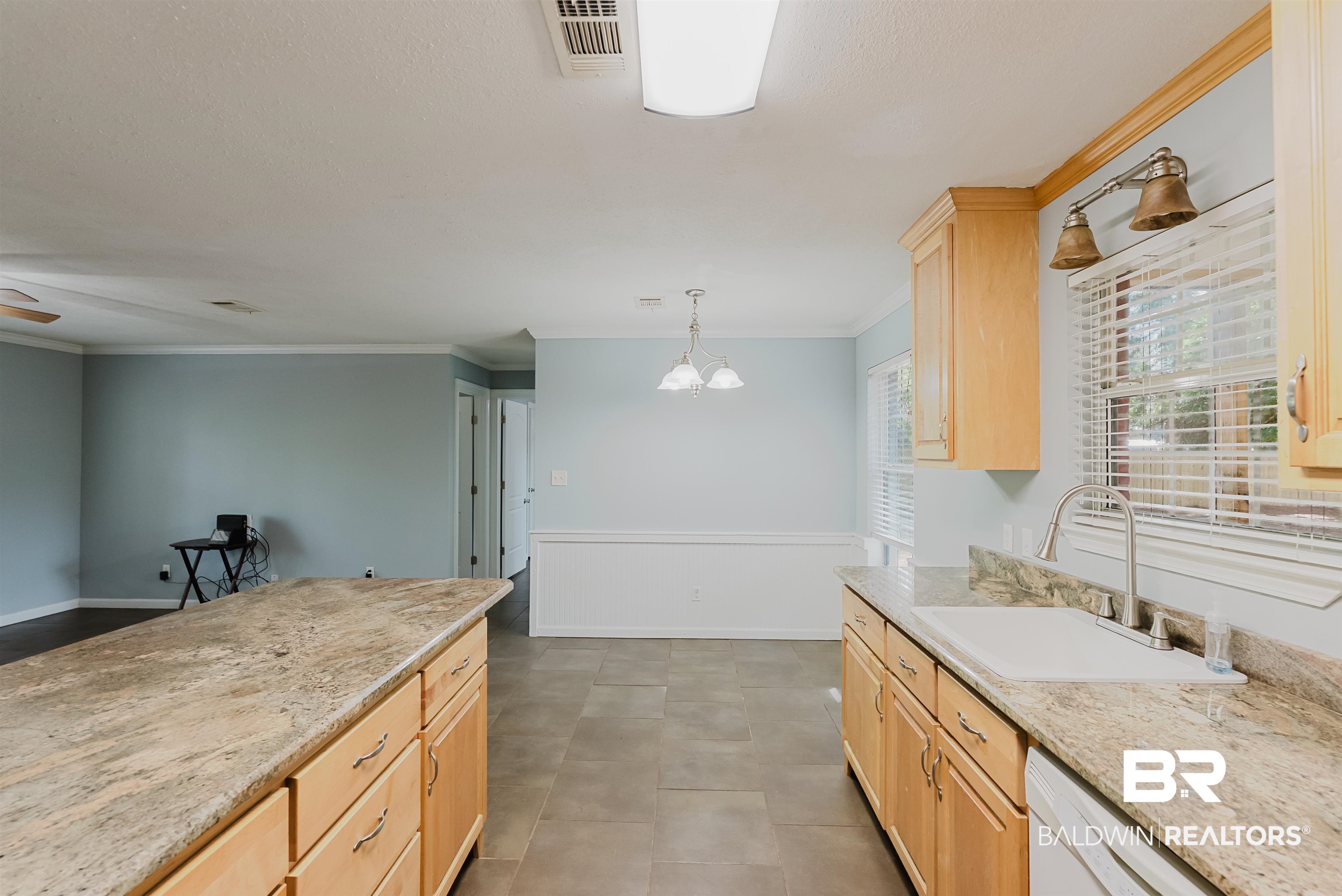 14185 Jackson Lane Foley, AL 36535 - Photo 3 of 16 Kitchen with light brown cabinetry, light stone counters, pendant lighting, white dishwasher, and crown molding