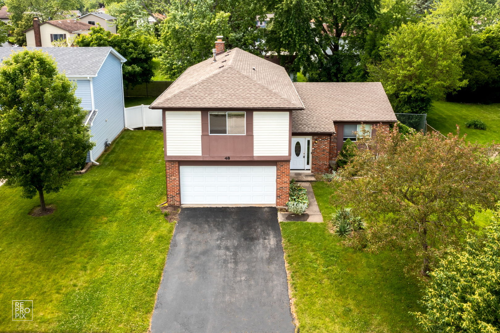 48 Pheasant Road Matteson, IL 60443 - Photo 1 of 23 a aerial view of a house with a yard and potted plants