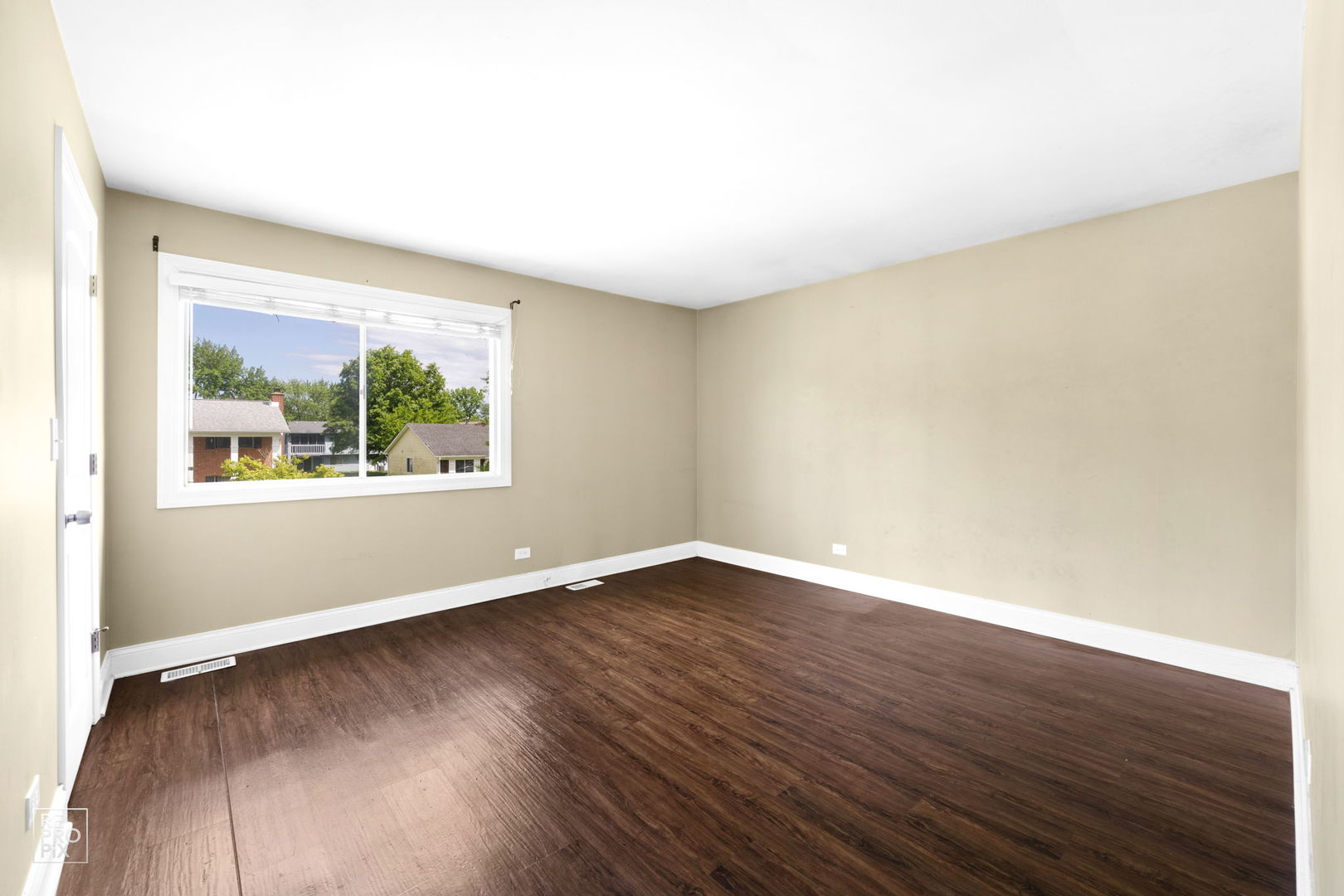 48 Pheasant Road Matteson, IL 60443 - Photo 15 of 23 an empty room with wooden floor and windows