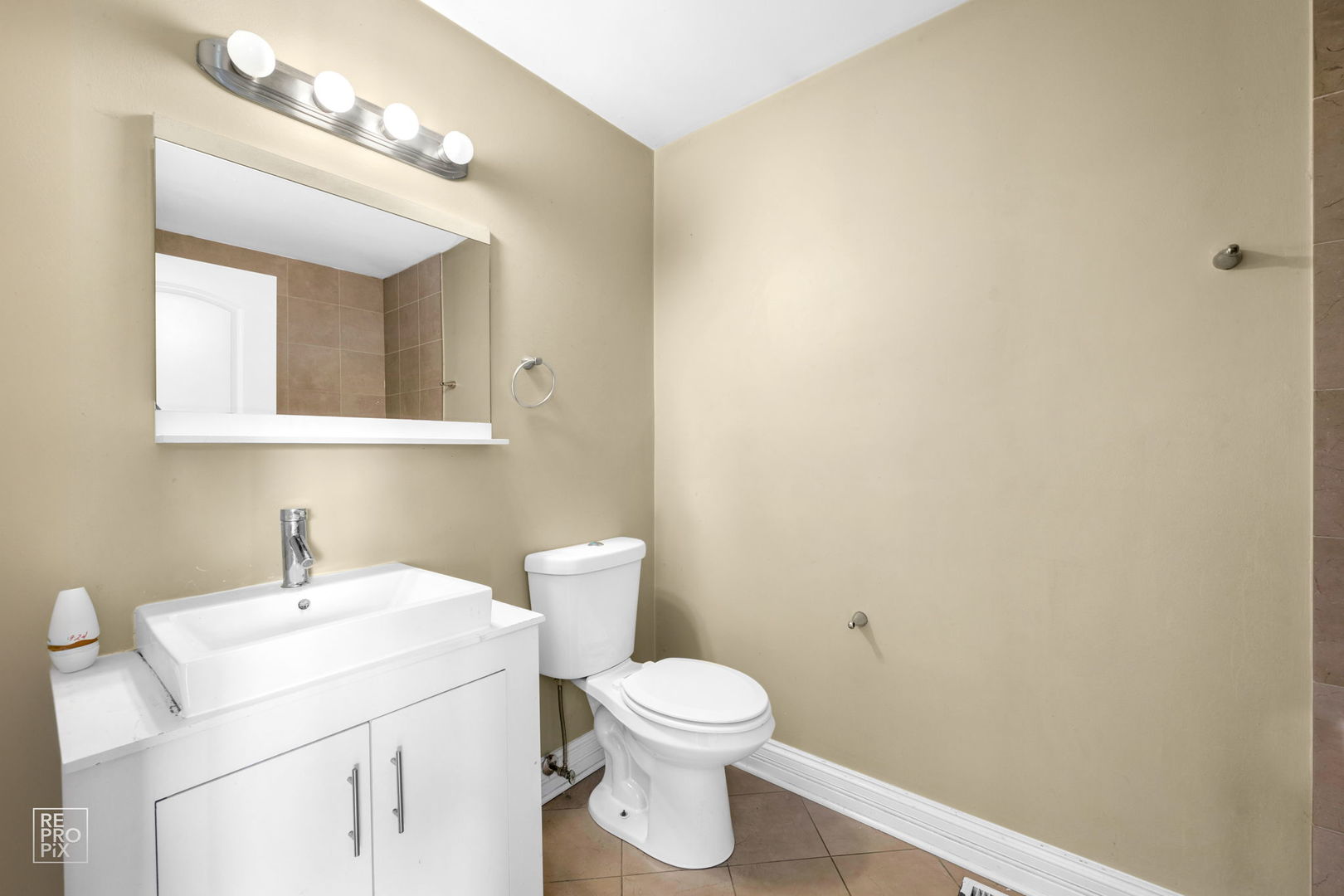 48 Pheasant Road Matteson, IL 60443 - Photo 16 of 23 a bathroom with a toilet a sink and mirror