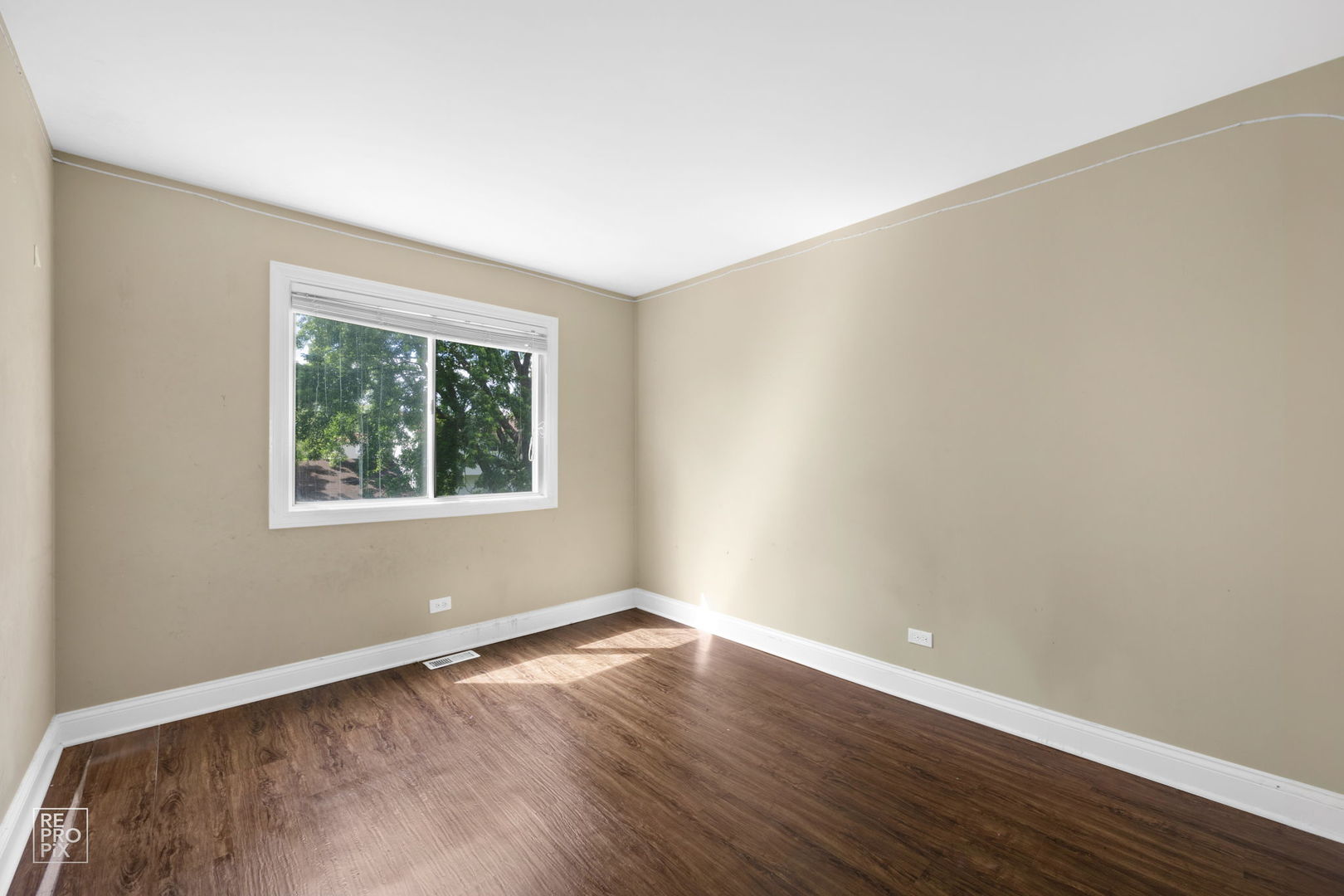 48 Pheasant Road Matteson, IL 60443 - Photo 22 of 23 a view of an empty room with wooden floor and a window
