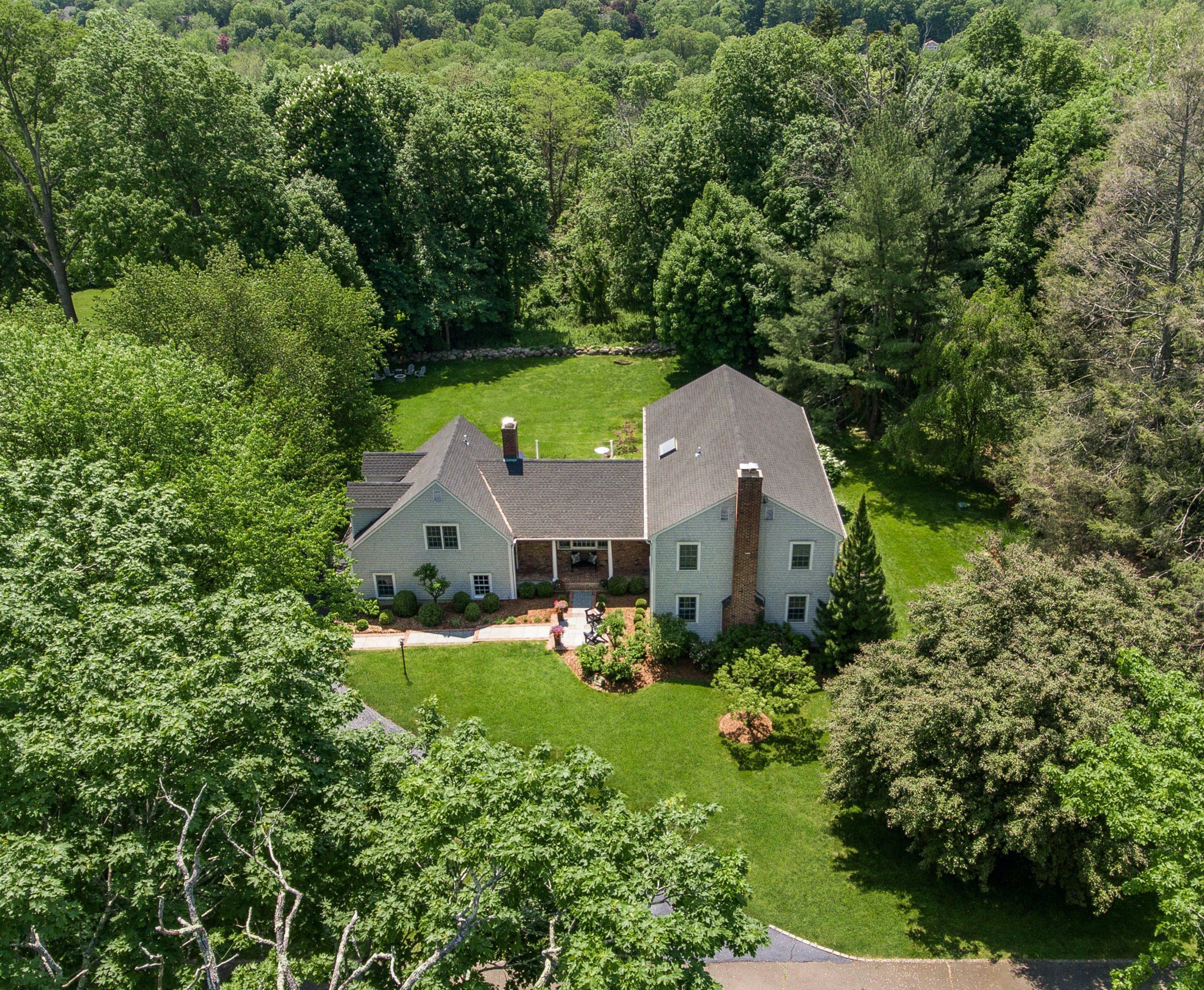 an aerial view of house with yard and green space
