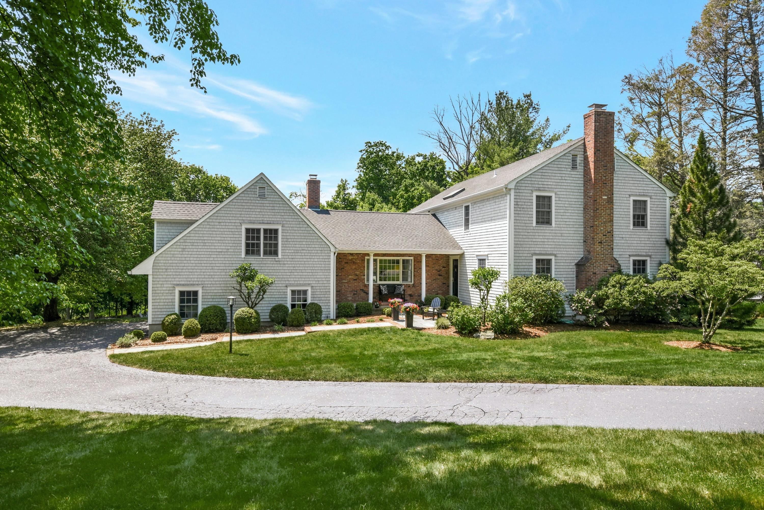 181 Brushy Ridge Road New Canaan, CT 06840 - Photo 2 of 34 a front view of a house with a yard and garage