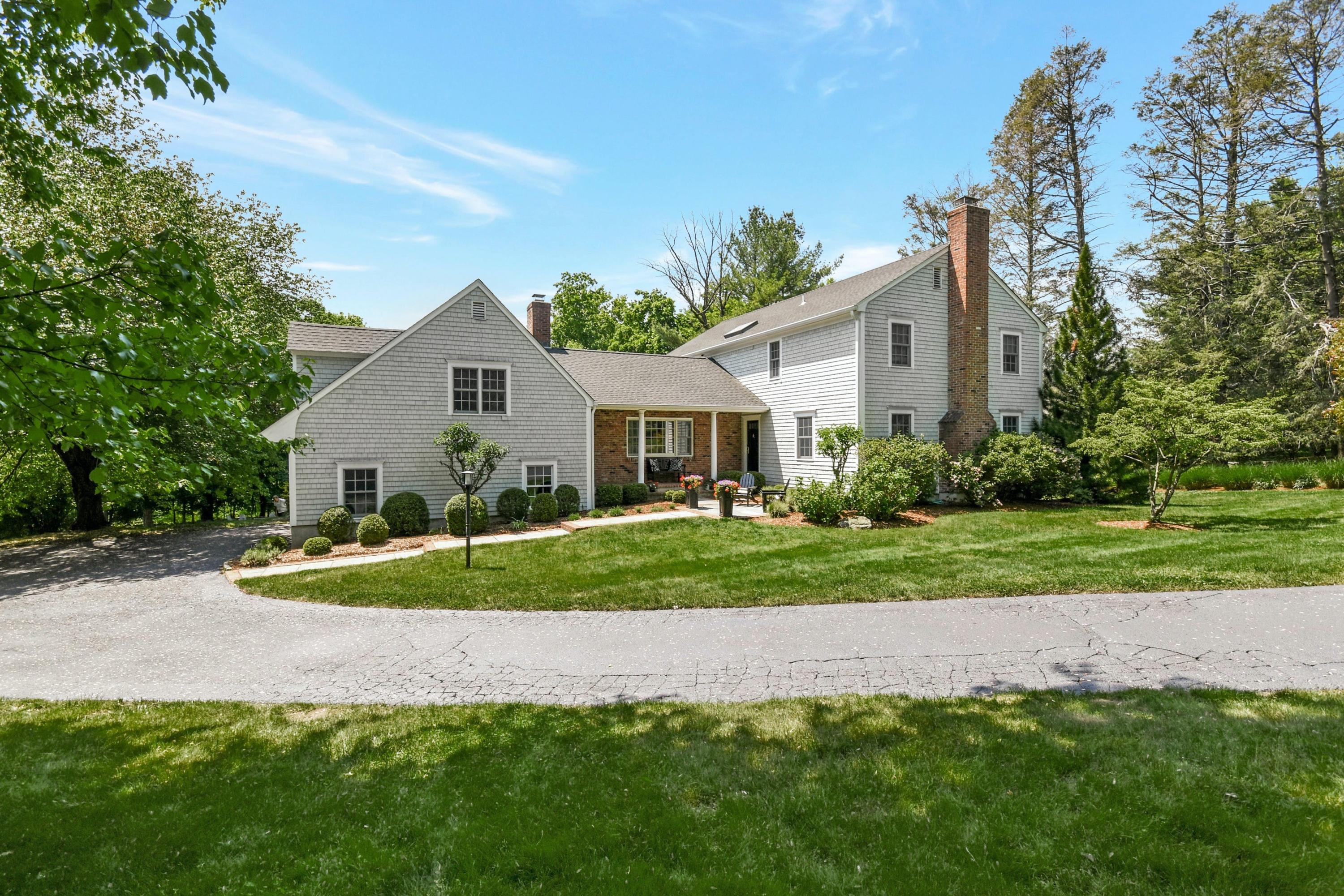 181 Brushy Ridge Road New Canaan, CT 06840 - Photo 34 of 34 a view of a house with a yard and plants