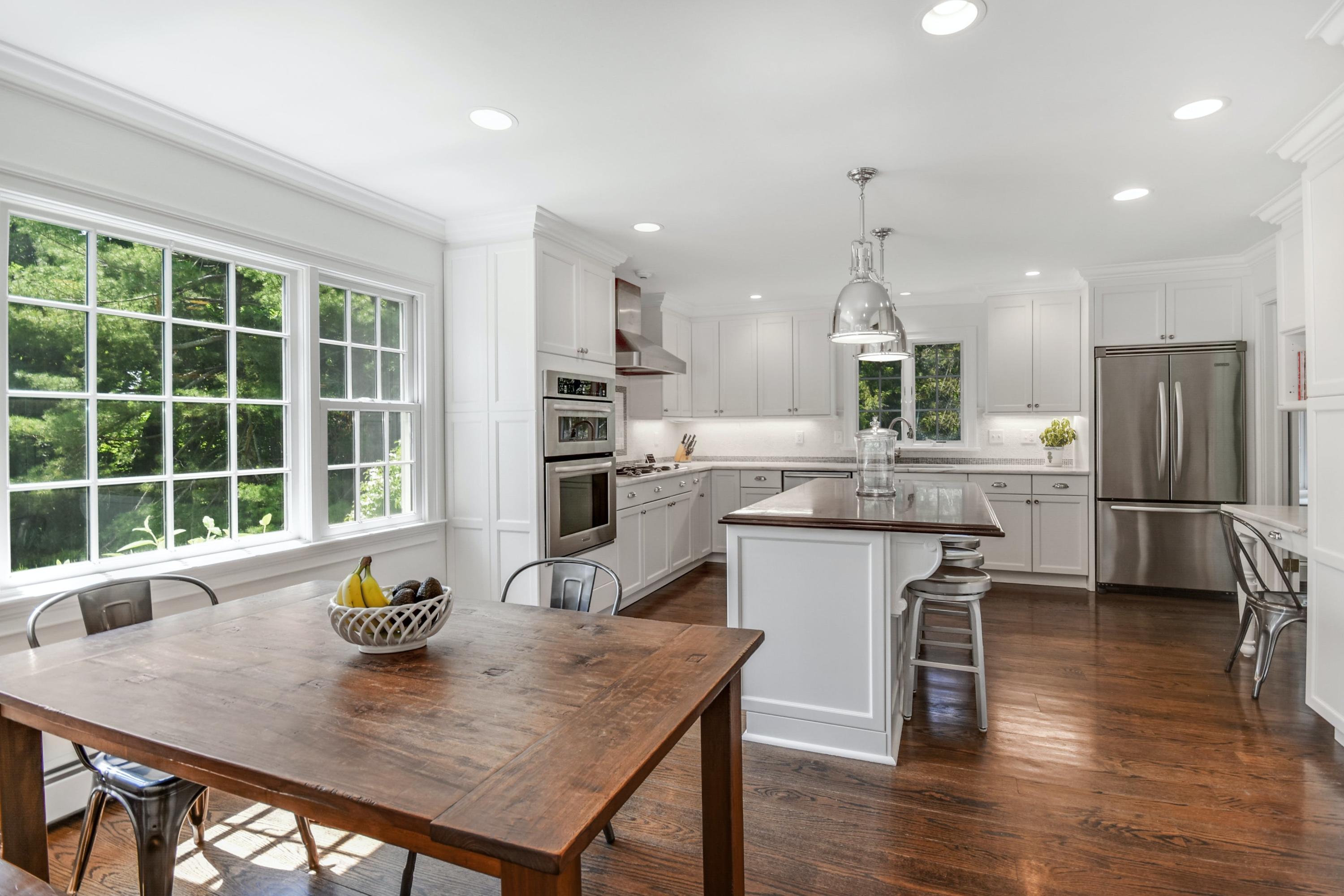 181 Brushy Ridge Road New Canaan, CT 06840 - Photo 8 of 34 a kitchen with a table chairs microwave and refrigerator