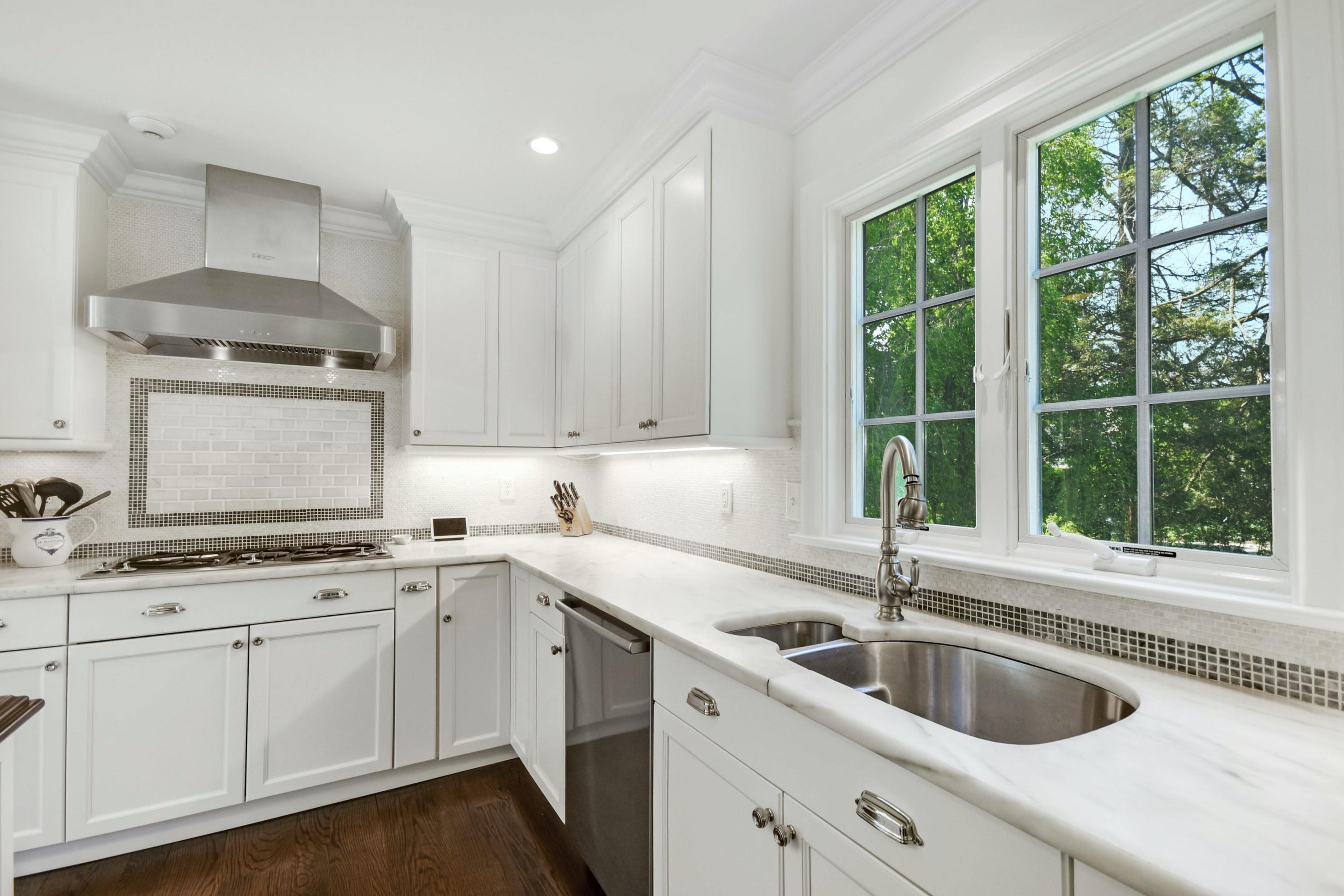 181 Brushy Ridge Road New Canaan, CT 06840 - Photo 9 of 34 a kitchen with a sink a stove a microwave and cabinets