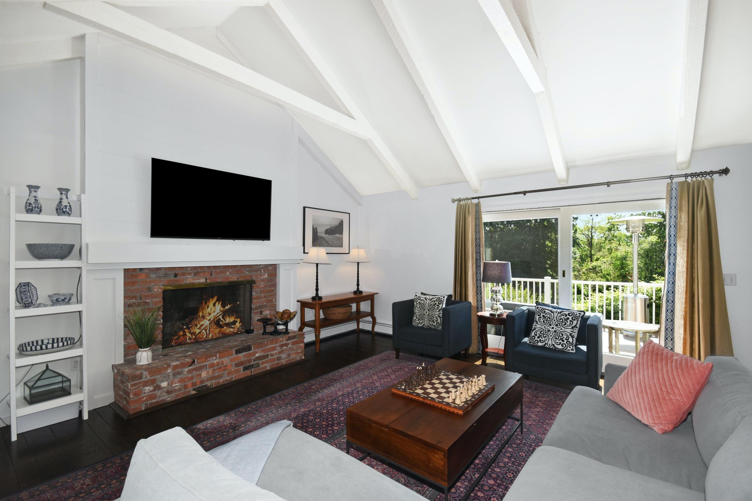 181 Brushy Ridge Road New Canaan, CT 06840 - Photo 10 of 34 a living room with furniture a fireplace and a flat screen tv