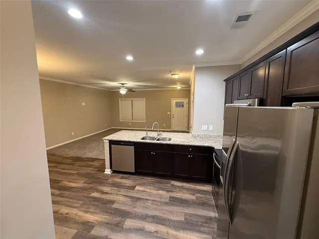 a large bathroom with a granite countertop sink and a refrigerator