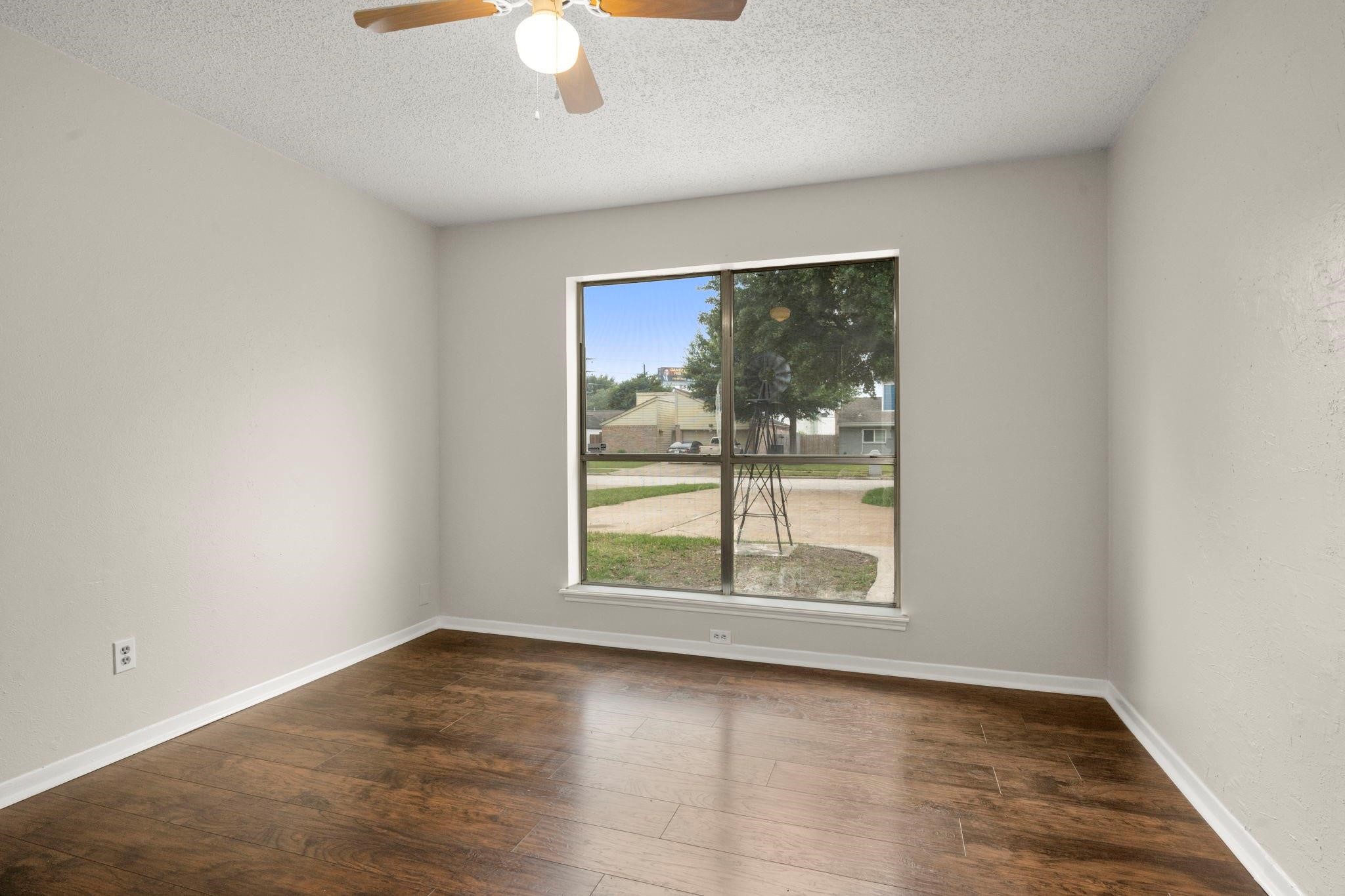 11718 Ridge Run Drive Houston, TX 77064 - Photo 4 of 17 an empty room with wooden floor and windows