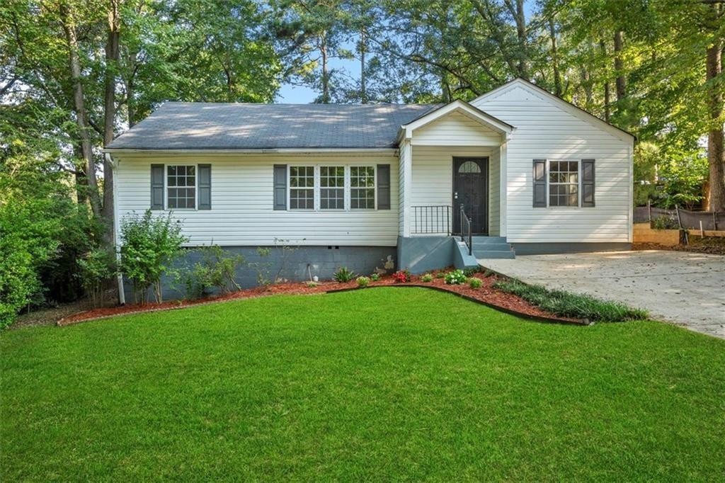 1917 Spring Avenue Atlanta, GA 30344 - Photo 1 of 22 a front view of a house with a yard and porch