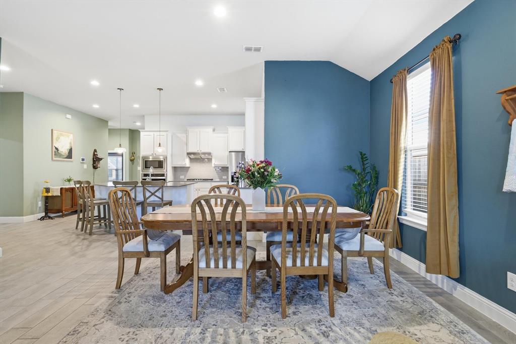 2213 Ruff Road Denton, TX 76205 - Photo 17 of 38 Open concept dining and living space with natural light, Ceramic Wood look tile flooring, and custom paint
