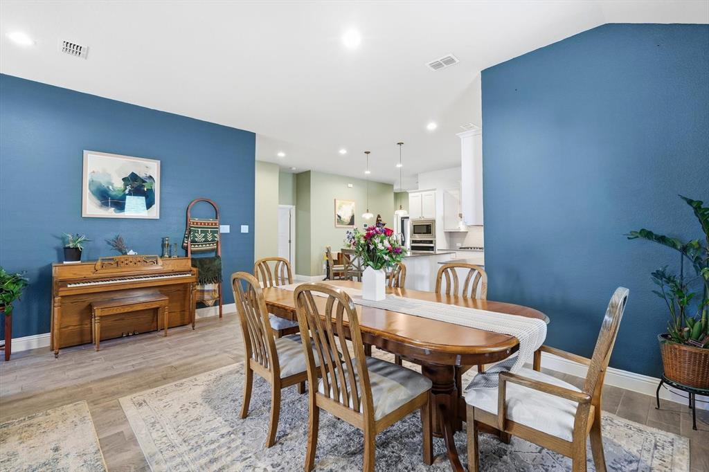 2213 Ruff Road Denton, TX 76205 - Photo 18 of 38 Open concept dining and living space with natural light, Ceramic Wood look tile flooring, and custom paint