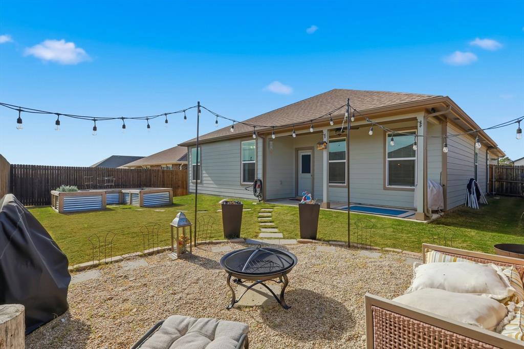 2213 Ruff Road Denton, TX 76205 - Photo 2 of 38 Rear view of property featuring a patio, a fenced backyard, a fire pit, and roof with shingles