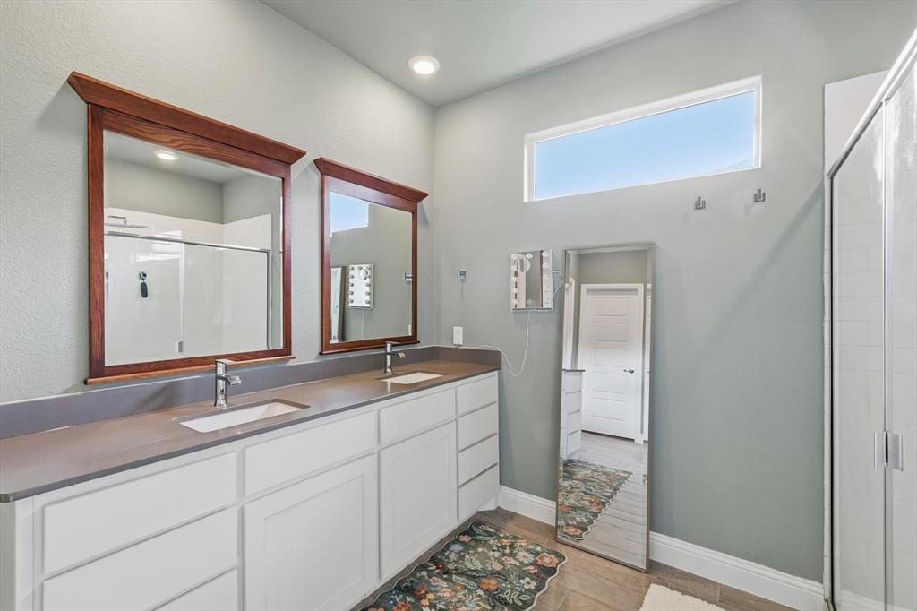 2213 Ruff Road Denton, TX 76205 - Photo 29 of 40 a bathroom with a double vanity sink and a mirror