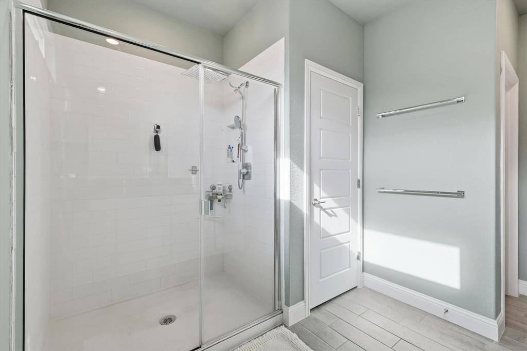 2213 Ruff Road Denton, TX 76205 - Photo 31 of 40 a bathroom with a glass shower door