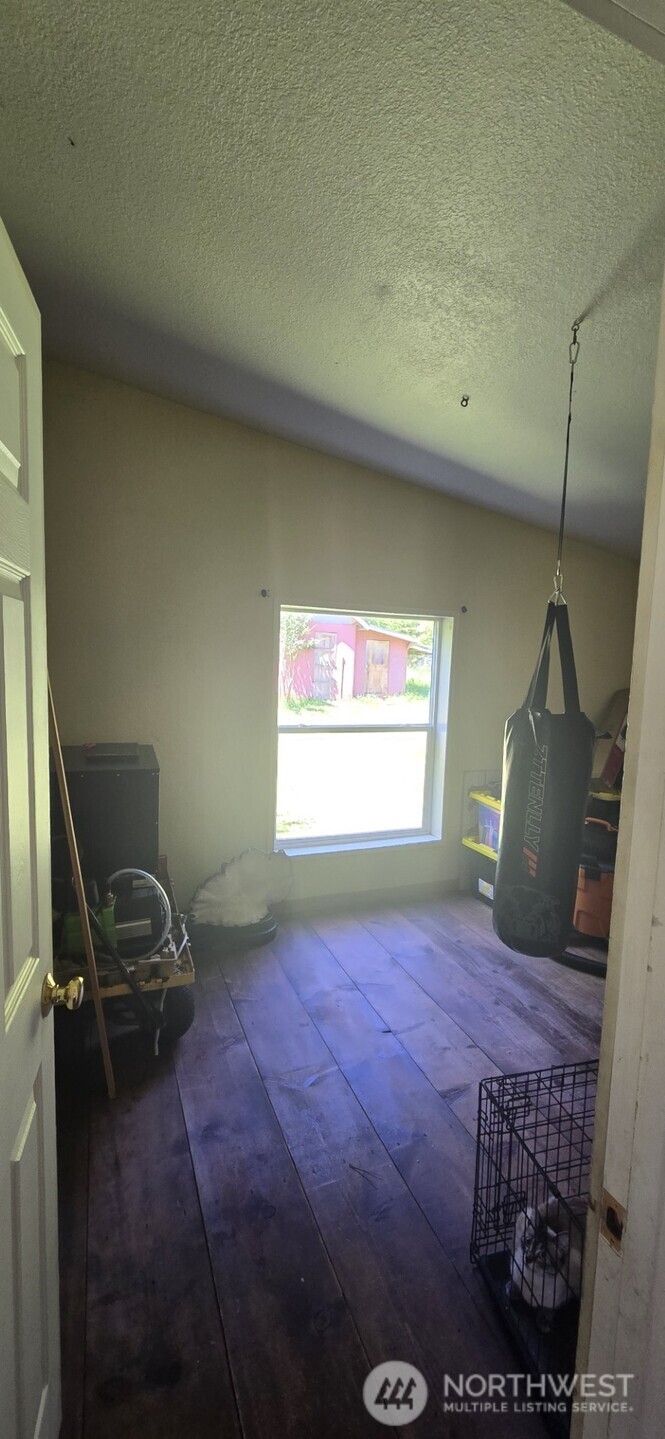 123 Barton Road Rochester, WA 98579 - Photo 24 of 25 a living room with a bed furniture and a window