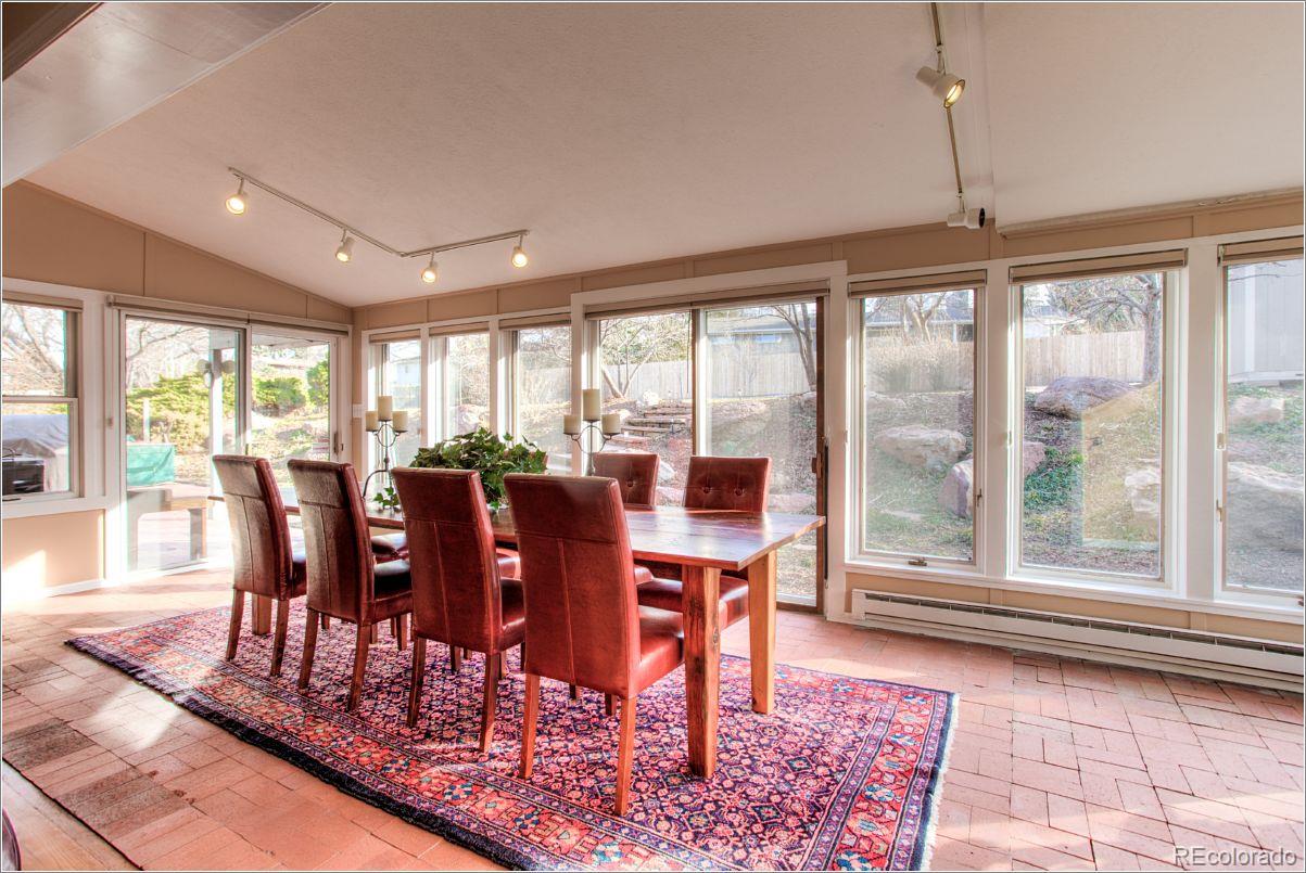 14130 Berry Road Golden, CO 80401 - Photo 12 of 28 a view of a dining room with furniture window and wooden floor