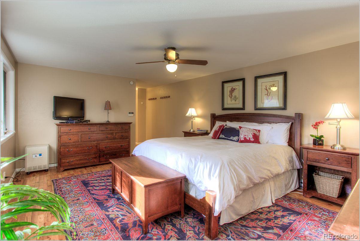 14130 Berry Road Golden, CO 80401 - Photo 16 of 28 a bedroom with a bed and a flat screen tv