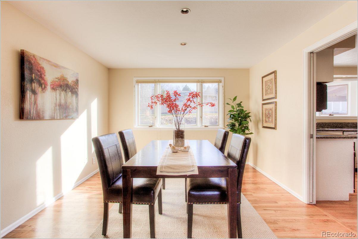 14130 Berry Road Golden, CO 80401 - Photo 6 of 28 a view of a dining room with furniture large window and wooden floor