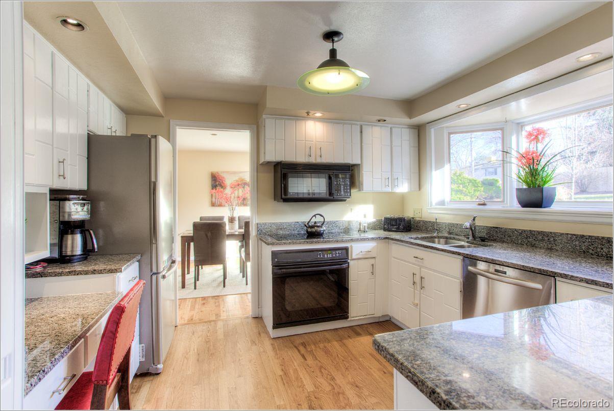 14130 Berry Road Golden, CO 80401 - Photo 8 of 28 a kitchen with stainless steel appliances granite countertop a sink and a stove
