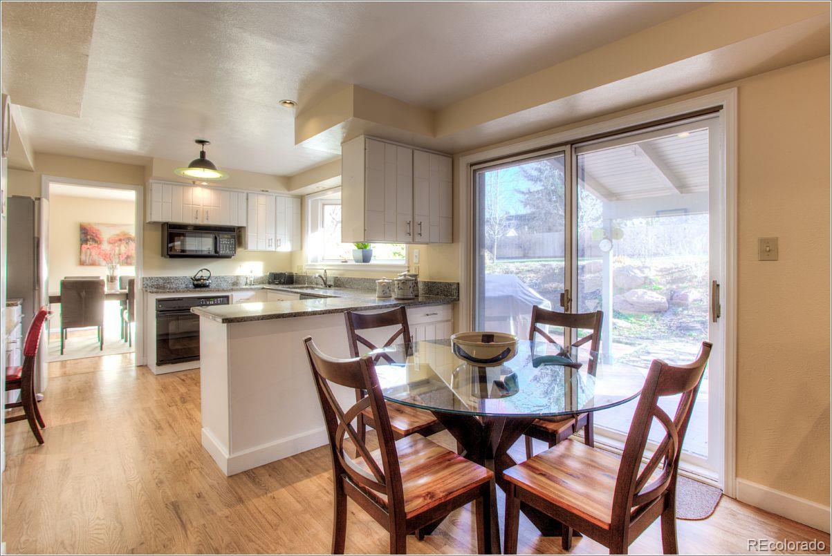 14130 Berry Road Golden, CO 80401 - Photo 10 of 28 a view of a dining room with furniture and wooden floor