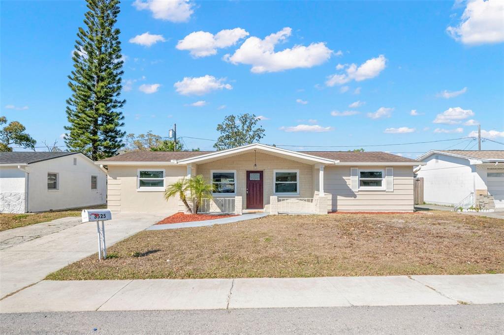 3525 Emory Drive Holiday, FL 34691 - Photo 1 of 1 a front view of a house with a yard and garage