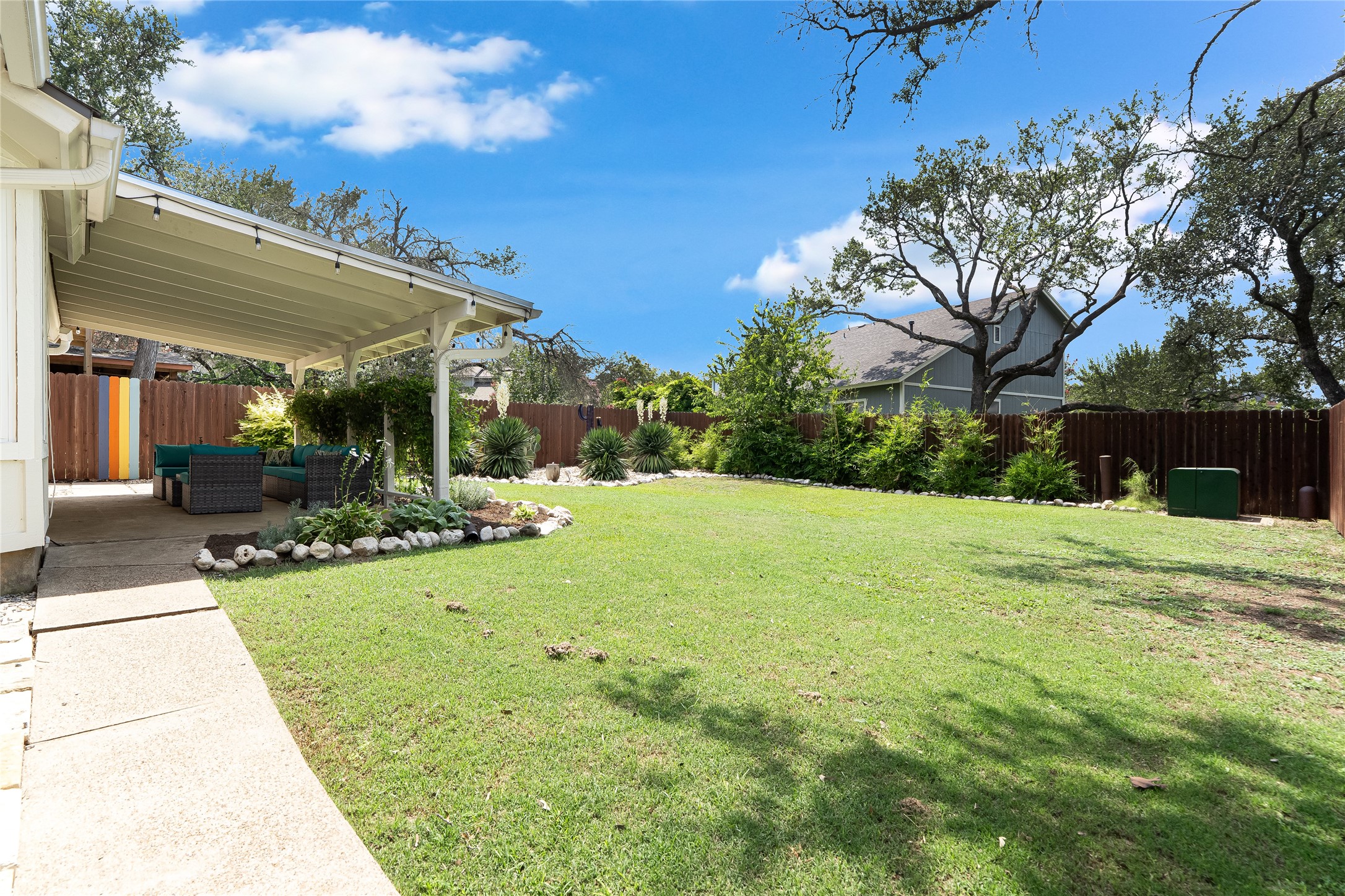 8104 Los Ranchos Drive Austin, TX 78749 - Photo 1 of 1 Fenced backyard with a patio and outdoor lounge area