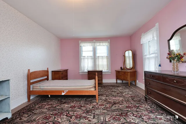 a living room with furniture a window and a dresser