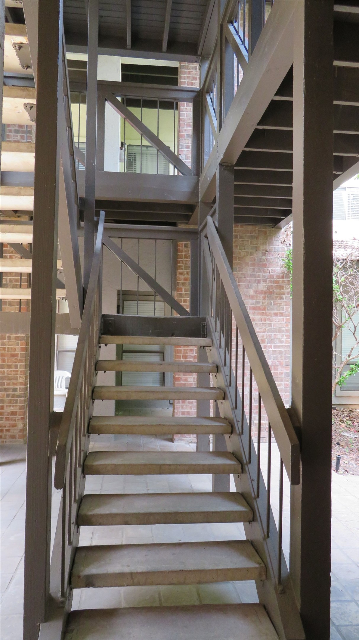 806 West 24th Street, Unit 200 Austin, TX 78705 - Photo 7 of 33 A robust outdoor staircase offers direct access to multiple levels within this brick-clad building.