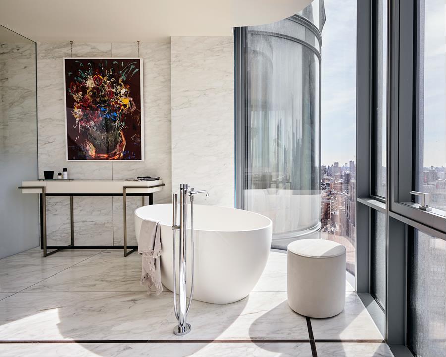 565 Broome Street, Unit N27B Manhattan, NY 10013 - Photo 2 of 22 a living room with a large window and white walls