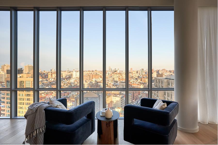 565 Broome Street, Unit N27B Manhattan, NY 10013 - Photo 4 of 22 a living room with furniture and floor to ceiling windows